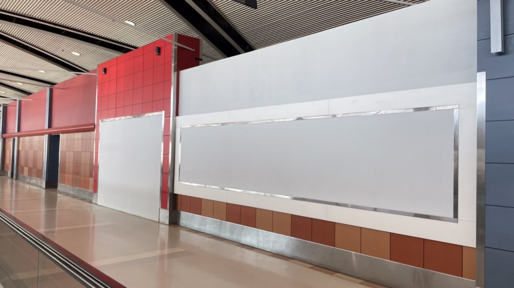 An empty, boarded-up storefront in Concourse B. Though it is Wendy’s Red, no Wendy’s signage is visible.